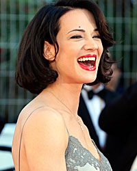 Actress Asia Argento poses on the red carpet as she arrives at the closing ceremony of the 66th Cannes Film Festival in Cannes