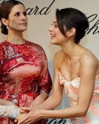 Actress Fan Bingbing speaks with actress Marion Cotillard and Livia Firth, creative director of Eco Age, during a photocall presenting the 'Green Carpet Collection' by luxury brand Chopard during the 66th Cannes Film Festival