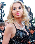 Italian businessman Massimo Gargia and model Valeria Marini pose on the red carpet as they arrive for the screening of the film 'Le Passe' (The Past) in competition during the 66th Cannes Film Festival