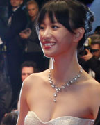 Cast members Li Meng and Jiang Wu pose on the red carpet as they arrive for the screening of the film 'Tian Zhu Ding' (A Touch of Sin) in competition during the 66th Cannes Film Festival