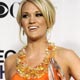 Carrie Underwood poses with her awards at the 35th annual People's Choice awards in Los Angeles