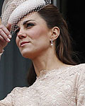 Britains Prince William and Catherine, Duchess of Cambridge gesture from the balcony of Buckingham Palace during the Queens Diamond Jubilee in central London