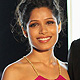 Freida Pinto and Dev Patel pose on the red carpet as they arrive for the opening of the 2011 Doha Tribeca Film Festival