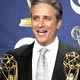 Jon Stewart holds his awards backstage at the 2005 Emmy Awards in Los Angeles.