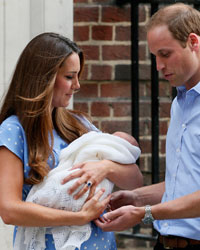 Britain's Prince William and his wife Catherine, Duchess of Cambridge appear with their baby son, as they stand outside the Lindo Wing of St Mary's Hospital, in central London