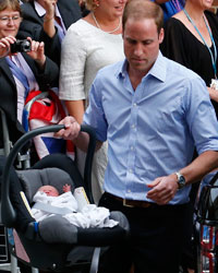 Britain's Prince William and his wife Catherine, Duchess of Cambridge leave with their baby son, from the Lindo Wing of St Mary's Hospital, in central London