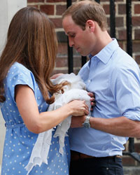 Britain's Prince William and his wife Catherine, Duchess of Cambridge appear with their baby son, as they stand outside the Lindo Wing of St Mary's Hospital, in central London