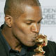 Jamie Foxx kisses his award won for best actor in a leading role-musical or comedy, for his role in 'Ray'