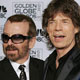 Mick Jagger (R) and Dave Stewart pose with their awards, won for best original song in a motion picture for 'Old Habits Die Hard' in the film 'Alfie' 