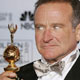 Actor/comedian Robin Williams poses back stage with the Cecil B. DeMille award he received