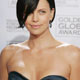 Actress Charlize Theron poses for photographers