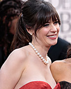 Actresses Deschanel and Louis-Dreyfus pose on the red carpet as they arrive at the 70th annual Golden Globe Awards in Beverly Hills