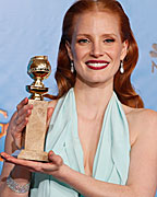 Jessica Chastain, winner for Best Actress in a Motion Picture, Drama for 'Zero Dark Thirty,' poses with her award backstage at the 70th annual Golden Globe Awards in Beverly Hills