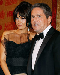 Brad Grey, chairman and CEO of Paramount Pictures and wife Cassandra Huysentruyt, pose at the HBO after party, after the 71st annual Golden Globe Awards