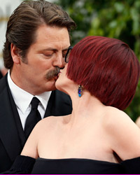 Actor Nick Offerman kisses his wife, actress Megan Mullally, on the red carpet at the 71st annual Golden Globe Awards in Beverly Hills, California