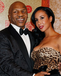 Former boxer Mike Tyson and wife Kiki pose at the HBO after party, after the 71st annual Golden Globe Awards in Beverly Hills, California