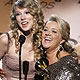 Taylor Swift and Liz Rose react onstage with their awards for best female country vocal performance for `White Horse` during the annual Grammy Awards in Los Angeles