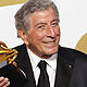 Singer Tony Bennett holds his Grammy awards backstage in Los Angeles