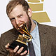 Singer Bon Iver bites one of his two Grammy Awards in Los Angeles