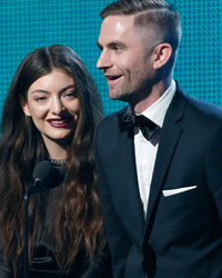 Lorde is accompanied by producer Joel Little after the won the award for Song of the Year for 'Royals' at the 56th annual Grammy Awards in Los Angeles, California