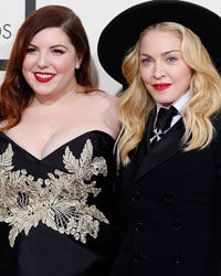 Madonna and her son, David Ritchie, pose with singer Mary Lambert (C) at the 56th annual Grammy Awards in Los Angeles, California