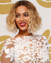 Beyonce poses backstage after performing at the 56th annual Grammy Awards in Los Angeles, California