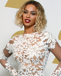 Beyonce poses backstage after performing at the 56th annual Grammy Awards in Los Angeles, California