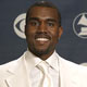 Rap singer Kanye West poses with the three Grammy awards he won at the 47th annual Grammy Awards at the Staples Center in Los Angeles.