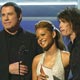 Actor John Travolta and singers Christina Millian and Steven Tyler present an award at the 47th Annual Grammy Awards in Los Angeles.