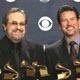 Producers Phil Ramone and John Burk hold the awards won by Ray Charles and his album 'Genius Loves Company' at the 47th annual Grammy Awards in Los Angeles.