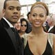 Singer Beyonce is escorted by singer Mario as they arrive at the 47th annual Grammy Awards at the Staples Center in Los Angeles.