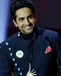 Ayushmann Khurrana speaks after receiving an award for the best performance in a leading role as actor Zayed Khan watches at the 14th annual International Indian Film Academy (IIFA) awards show in Macau