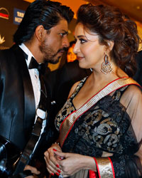 Shah Rukh Khan and Madhuri Dixit arrive on the green carpet before the 14th annual International Indian Film Academy (IIFA) awards show in Macau