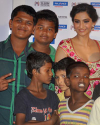 Sonam Kapoor with the street kids who have acted in the film Little Big People during the promotion of the film at the 15th Mumbai Film Festival