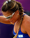 Argentina's Maria Virginia Zonta gets up after they scored a point against the Netherlands' Marleen van Iersel and Sanne Keizer during their women's preliminary round beach volleyball match