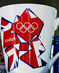 A commemorative cup for the London 2012 Olympic Games sits next to a Big Ben clock tower tea pot in a shop window in London