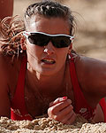 Britain's Zara Dampney falls to the ground during their women's beach volleyball preliminary round match against Canada at the London 2012 Olympics Games