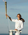 Torch bearer Amelia Hempleman-Adams, age 17, stands on top of a capsule on the London Eye as part of the torch relay ahead of the London 2012 Olympic Games in London