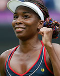 Venus Williams of the U.S. celebrates after defeating Canada's Wozniak in their women's singles tennis match at the All England Lawn Tennis Club during the London 2012 Olympic Games