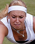 Germany's Lisicki reaches for a return to Kazakhstan's Shvedova in their women's singles tennis match at the All England Lawn Tennis Club during the London 2012 Olympic Games