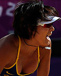 China's Zhang Xi celebrates a point during their women's preliminary round beach volleyball match against Switzerland at the London 2012 Olympic Games at Horse Guards Parade