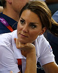 Britain's Catherine, Duchess of Cambridge, listens to an official as she attends the track cycling events with Prince William and Prince Harry