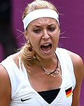 Germany's Lisicki celebrates after winning the first set in her women's singles tennis match against Russia's Sharapova