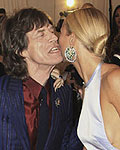 Singer Mick Jagger greets Gwyneth Paltrow as he arrives with L'Wren Scott at the Metropolitan Museum of Art Costume Institute Benefit