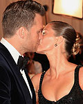 New England Patriots NFL quarterback Tom Brady kisses his wife Gisele Bundchen, as they arrive at the Metropolitan Museum of Art Costume Institute Benefit