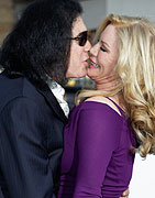 Musician Gene Simmons kisses wife Shannon Tweed as they arrive as guests at the premiere of the new film 'Oblivion' in Hollywood, California