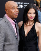 Russell Simmons, co-founder of Def Jam records, poses with his girlfriend German model Hana Nitsche at the premiere of the new film 'Pain