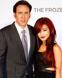 Actor Nicolas Cage (L) and his wife Alice Kim pose at the UK Premiere of 'The Frozen Ground' at Leicester Square in London