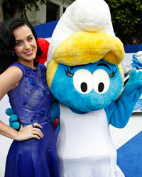 Singer Katy Perry poses with the Smurfette character she voiced, at the premiere of 'The Smurfs 2' at the Regency Village theatre in Los Angeles, California