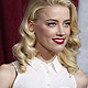 Amber Heard poses at the premiere of 'Sherlock Holmes: A Game of Shadows' at the Village theatre in Los Angeles